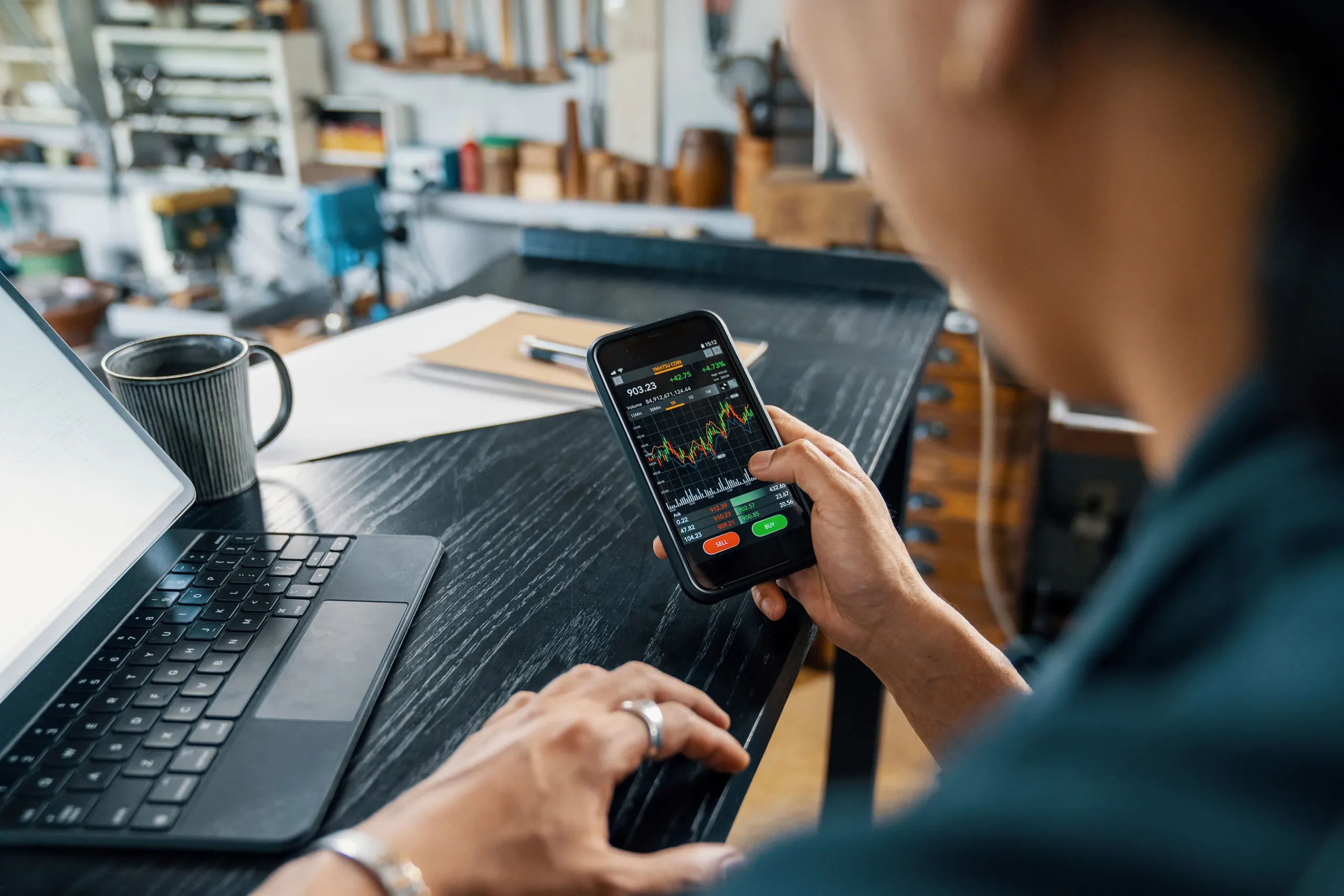 Trader reviewing live charts on a smartphone